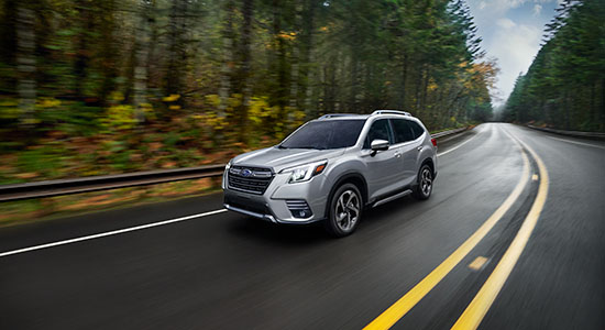 The 2022 Subaru Forester driving on a road.